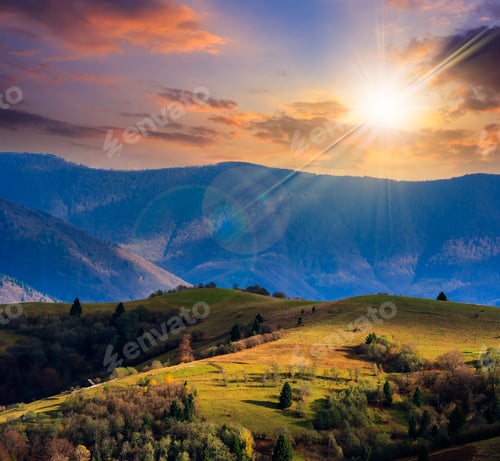 Preview: Mountain Fall Landscape. Pine Trees Near Meadow And Forest On Hillside Under Sky With Clouds At