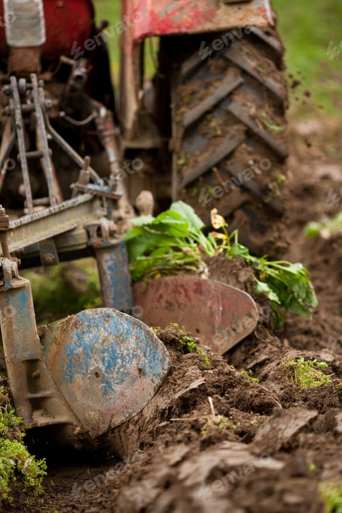 Preview: Close Up Of The Rear End Of A Tractor While Plowing, Some Motion Blur Present
