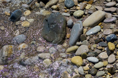 Preview: Pebble Stones On The Sea Beach On A Warm Summer Day, The Rolling Waves Of The Blue Sea With White