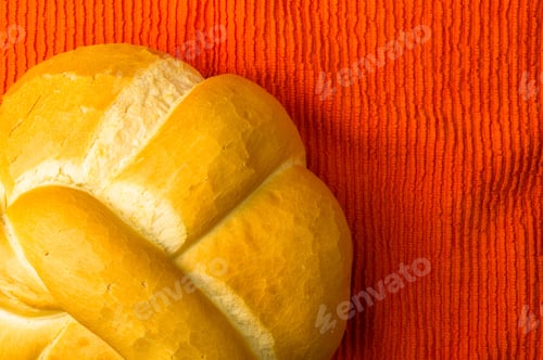 Preview: Fresh Braided Loaf Of White Wheat Bread On An Orange Napkin