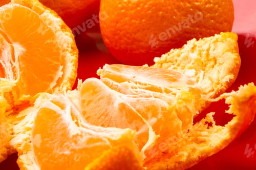 Preview: Tangerines, Peeled Tangerine And Tangerine Slices In A Red Plate On Black Background