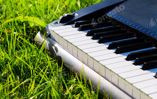Preview: Piano Keyboard On The Green Grass With A Sunlight