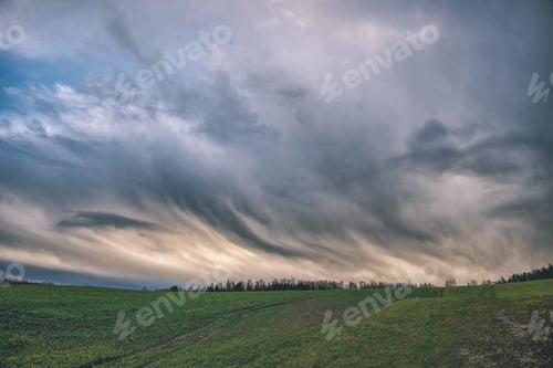 Preview: High Contrast Clouds On Blue Sky Over Natural Landscape In Summer At Sunset Time - Vintage Retro