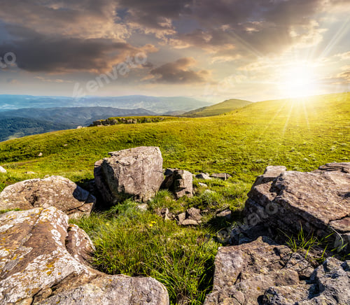 Preview: Mountain Landscape With Stones Laying Among The Grass On Top Of The Hill Side Under The Cloudy
