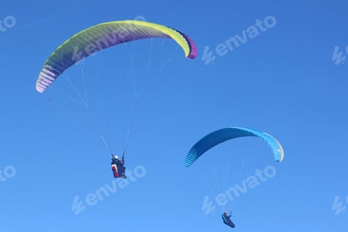 Preview: Paragliders Flying In A Blue Sky