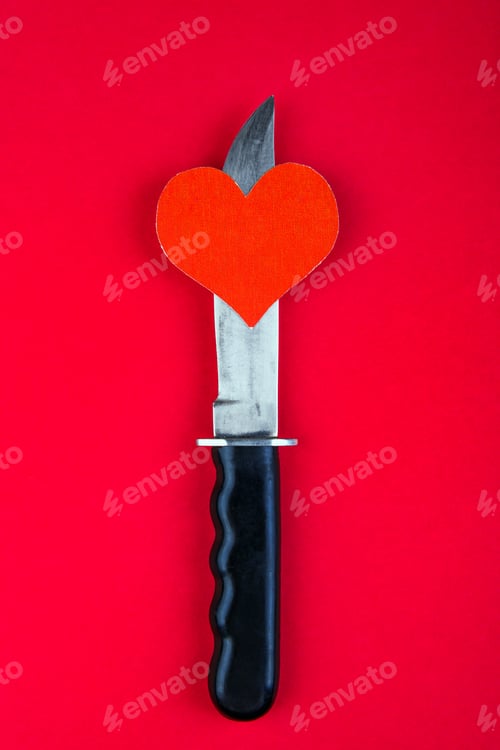 Preview: Heart Shape And A Knife On The Red Paper Background