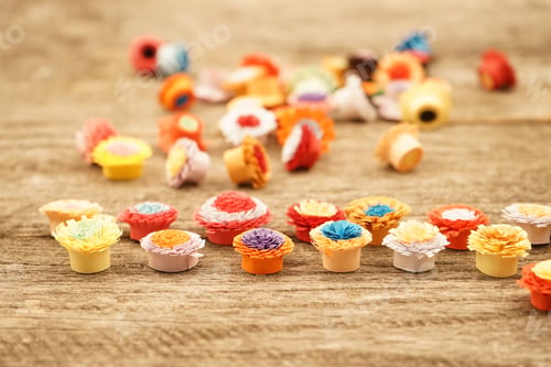 Preview: Small, Colorful Paper Flowers Made With Quilling Technique On A Wooden Surface