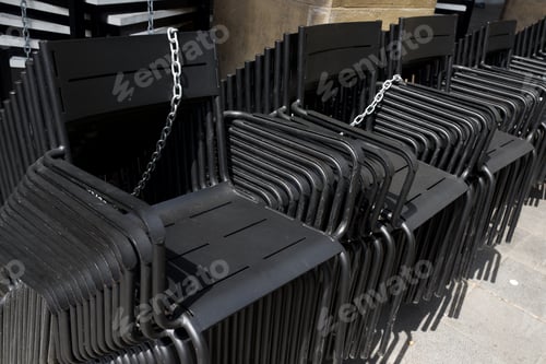 Preview: Metal Chairs Stacked In The Street.