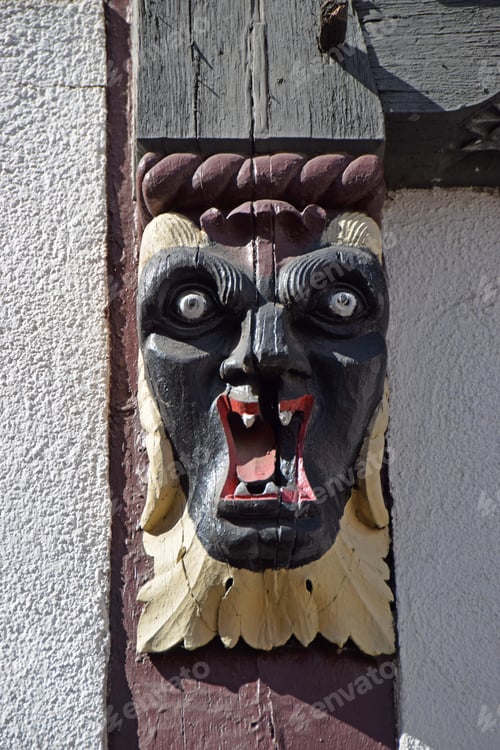 Preview: Carved Grimace On A Hessian Half-Timbered House