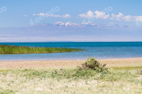 Preview: Beach At Lake Issyk Kul, Kyrgyzstan, Central Asia. Tian Shan Mountains In The Background.