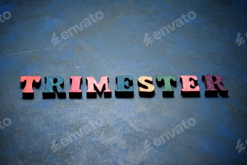 Preview: Trimester Word On A Blue Table.