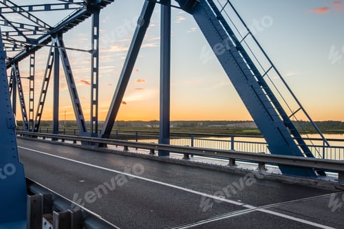 Preview: Railway Bridge With Metal Rails Near River In Sunset