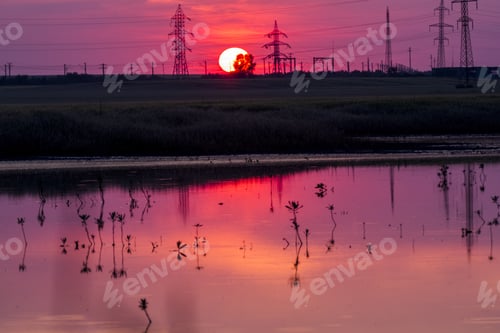 Preview: Beautiful, Dramatic, Colorful Clouds And Sky At Sunset. Electrical Wires And Stakes And Water