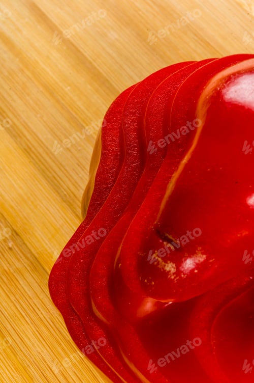 Preview: Stacked Pile Of Sliced Fresh Red Paprika, Bell Pepper On Bamboo Cutting Board