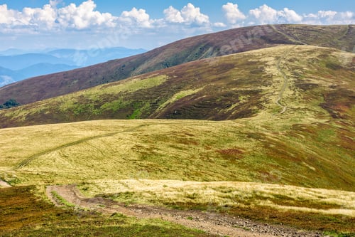 Preview: Winding Road Through Large Meadows On The Hillside Of Mountain Range