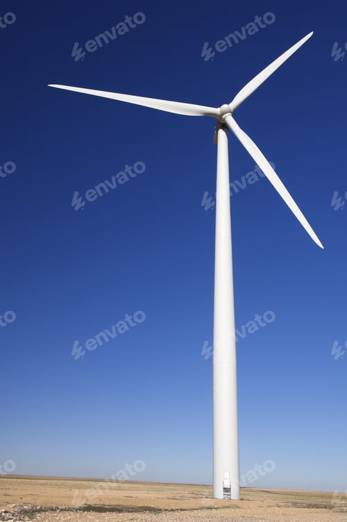 Preview: Modern Windmill In A Meadow With Blue Sky