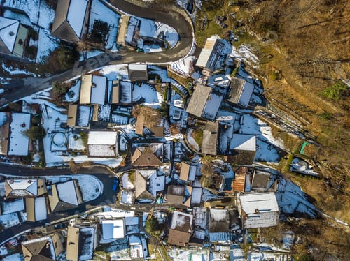 Preview: Arial View Of Village In Swiss Mountains In Ticino In Winter With Snow Covered Roofs