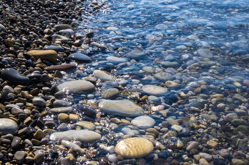 Preview: Sea Pebble Beach With Multicoloured Stones, Transparent Waves With Foam, On A Warm Summer Day