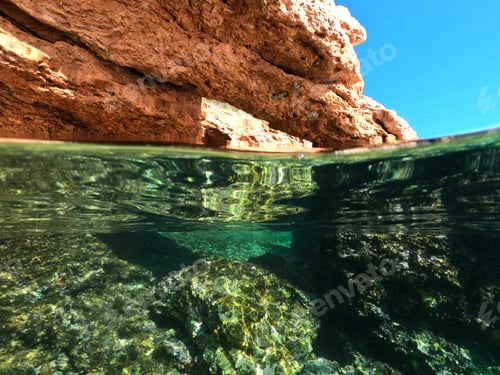 Preview: Underwater Split Photo Of Exotic Bay With Emerald Colours And Rocky Seascape