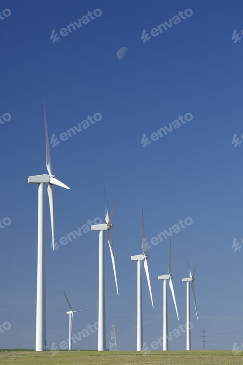 Preview: Windmills Group Aligned With Moon And Blue Sky