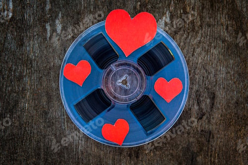Preview: Vintage Reel With A Tape And With Red Hearts On The Grunge Background Closeup