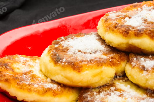 Preview: Red Plate Of Pancakes In Powdered Sugar On Black Background