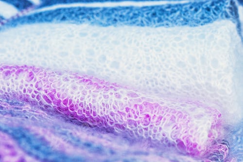 Preview: Knitted Pink, White And Gray Woolen Fabric Close Up. Winter Wear Knitted Fabric Texture.
