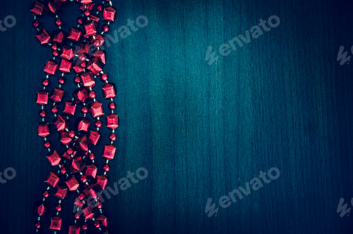 Preview: Group Of Red Beads Over Wooden Background