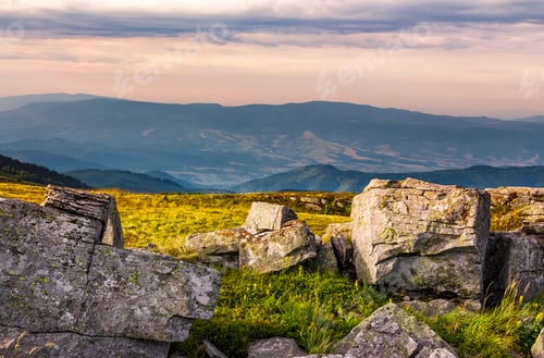 Preview: Sunset Light On Hills With Stones. Beautiful Mountainous Landscape On A Cloudy Day