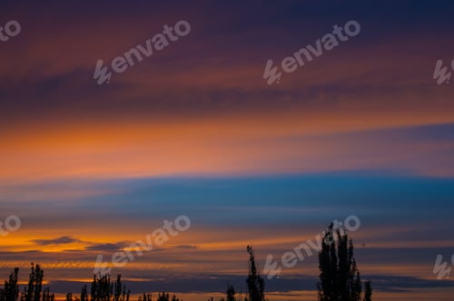 Preview: Landscape With Dramatic Light - Orange Clouds And The Outline Of Trees At Sunset