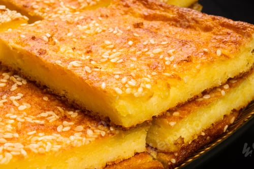 Preview: Slice Of Cheesecake With Sesame Seeds On A Black Background