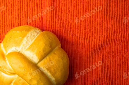 Preview: Fresh Braided Loaf Of White Wheat Bread On An Orange Napkin