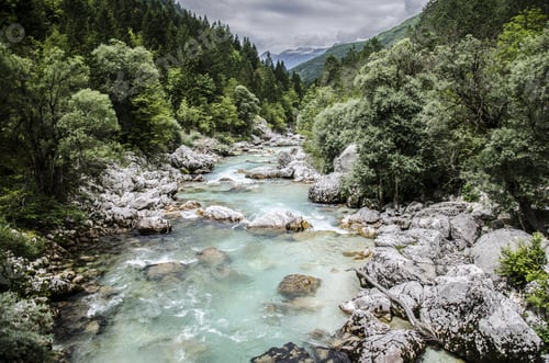 Preview: Smaragd River In The Mountains With Forest Surrounding It
