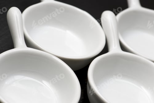 Preview: Four Small White Spoons On A Table Slate