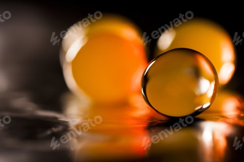 Preview: Abstract Composition With Beautiful, Orange, Round Jelly Balls On An Aluminium Foil With Reflexions
