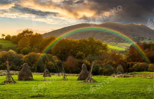 Preview: Composite Agriculture Landscape With Stack Of Hay On A Green Meadow Near Forest Near The Foot Of