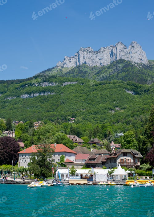 Preview: Scenery Of Annecy Lake Over Alps With Paragliders Above On Sunny Day.