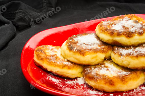 Preview: Red Plate Of Pancakes In Powdered Sugar On Black Background