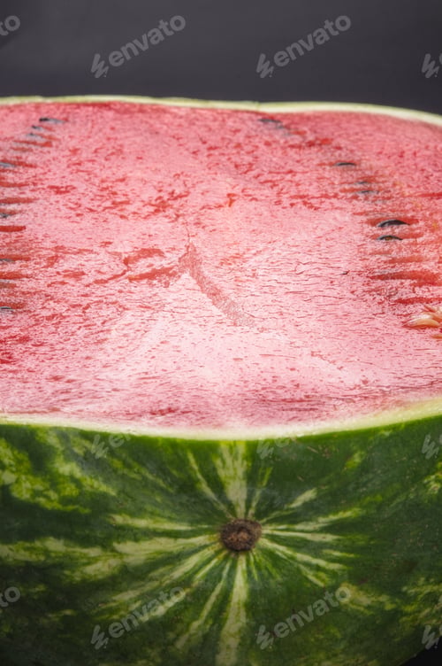 Preview: Half Of Ripe Watermelon On A Black Background