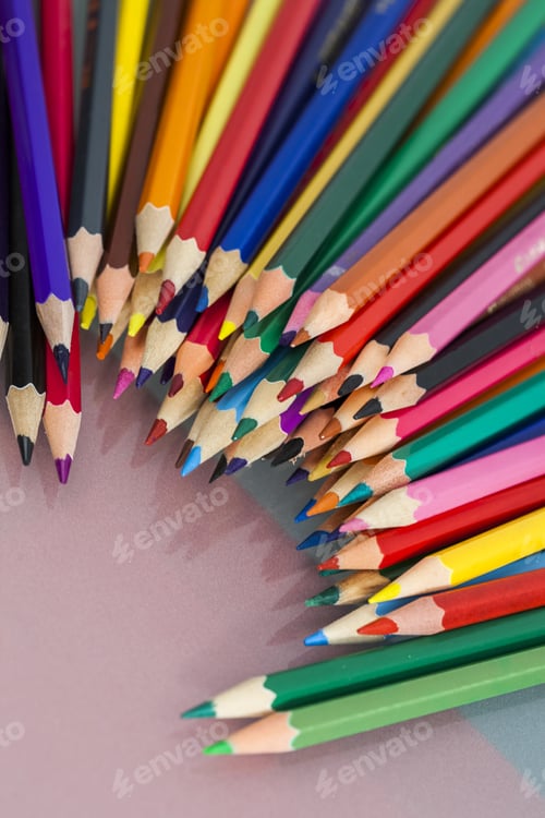 Preview: Group Of Sharp Colored Pencils With White And Red Background And Reflexions