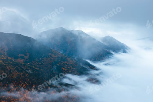 Preview: Foggy Mountain Landscape With Clouds Above The Peaks