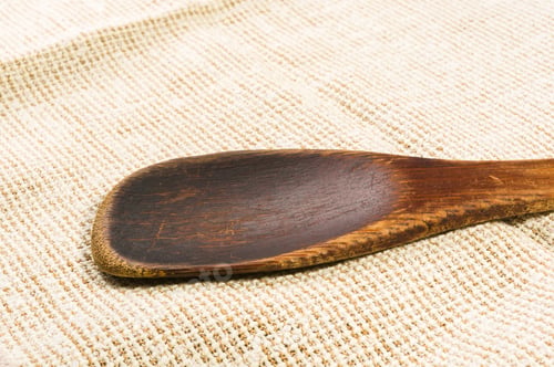 Preview: Rustic Coarse Canvas Fabric And A Worn Wooden Spoon, Close-Up, Background