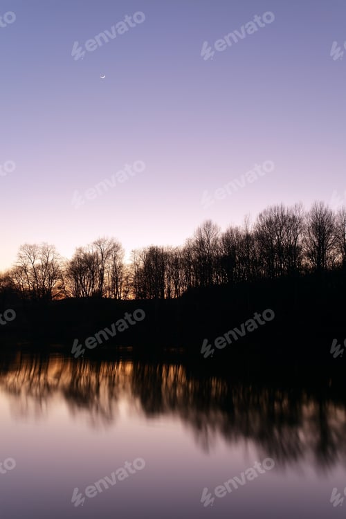 Preview: Lake With Silhouette Of Trees At Sunset.