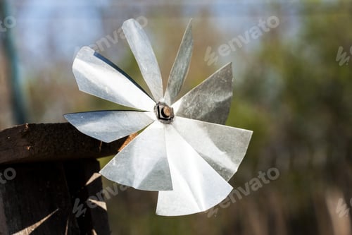 Preview: Metallic Piece Made To Whistle In The Wind With Spring Background