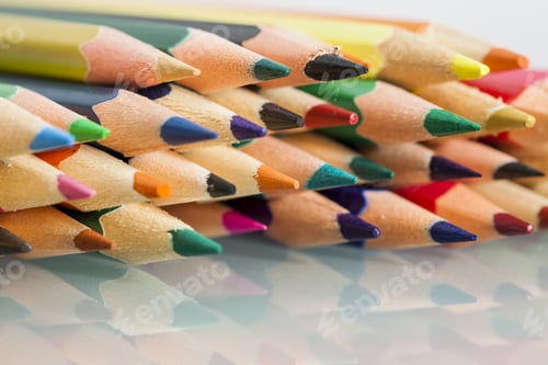Preview: Group Of Sharp Colored Pencils With White Background And Reflexions