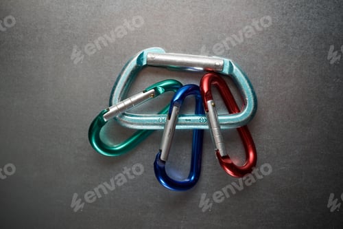 Preview: Small Carabiners On A Metal Table.
