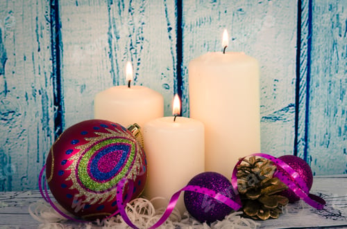 Preview: White Burning Candles Decoration, Purple Christmas Baubles Against Blue Wooden Background