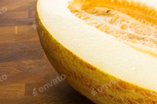 Preview: Half Of Ripe Juicy Melon On Wooden Background
