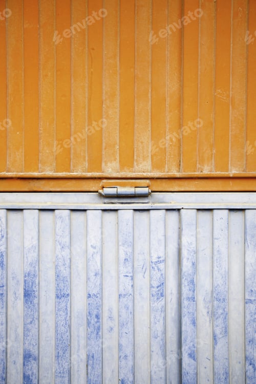 Preview: Wall Decorated Metal, Detail Of A Closed Metal Door, Painted In Orange And Blue