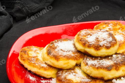 Preview: Red Plate Of Pancakes In Powdered Sugar On Black Background